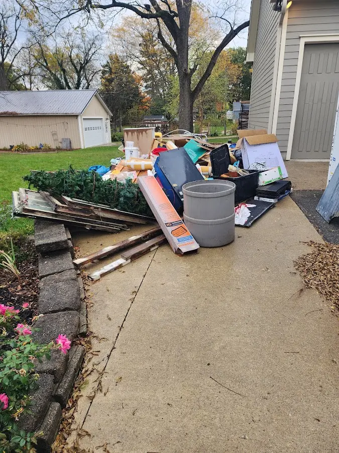 Dumpster being loaded with debris for Residential Dumpster Rental in Moss Point